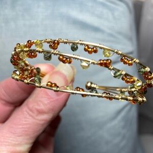 Vintage gold tone wire cuff bracelet with gemstones in topaz, clear, grey 2.5x2”